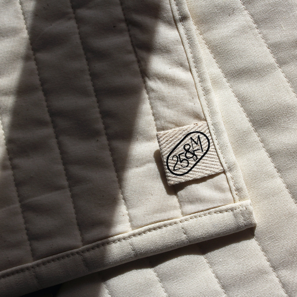 Close-up of a textured fabric surface with a brand label.