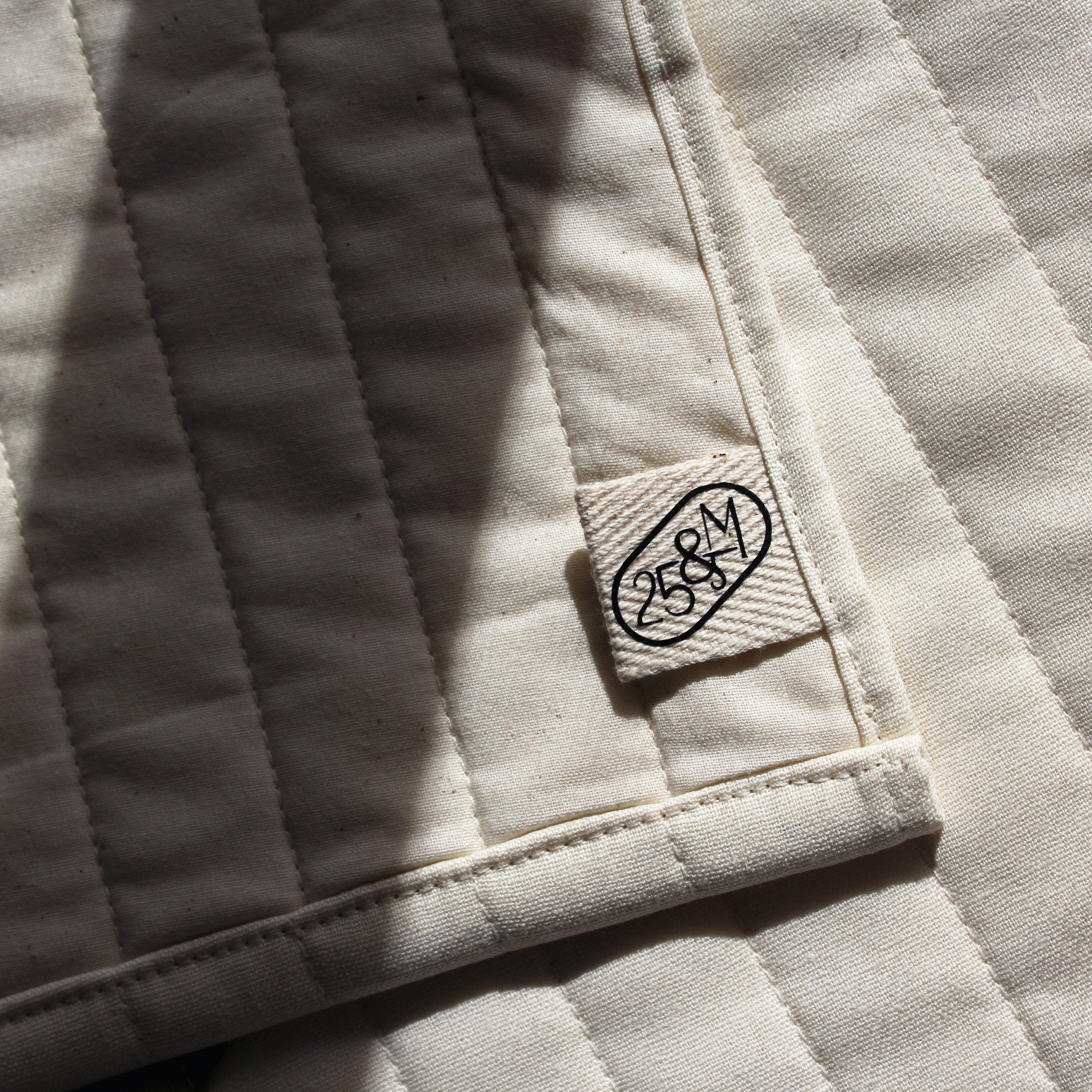 Close-up of a textured fabric surface with a brand label.
