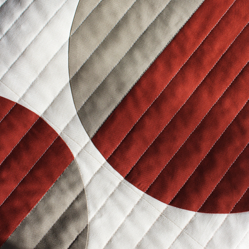 Close-up of a textured fabric with red, gray, and white colors.