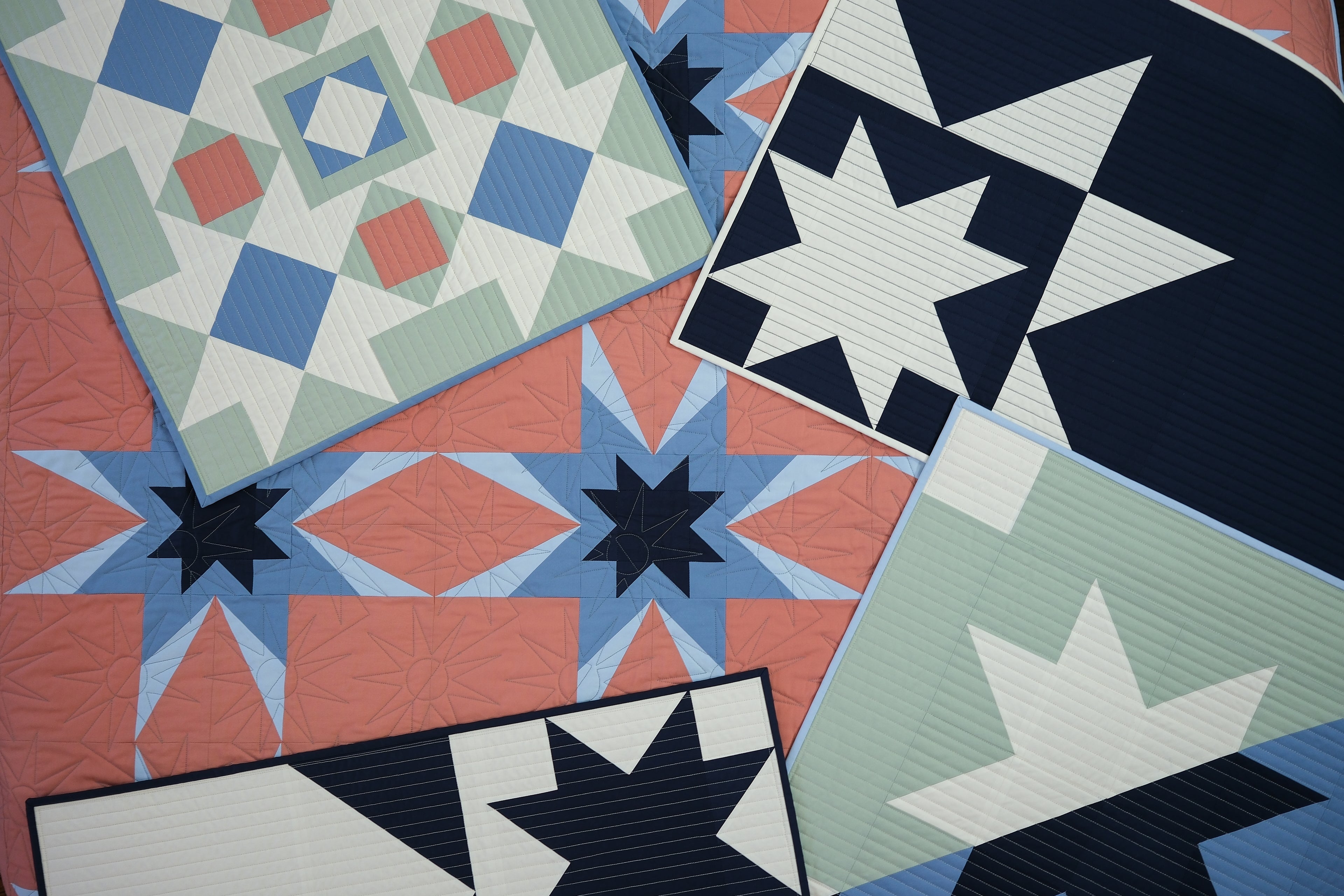 Collection of star-patterned quilts in various colors and designs.