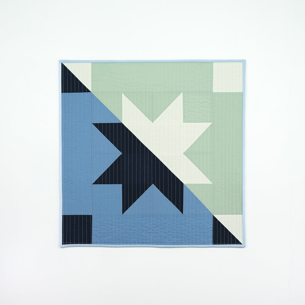 Quilt with geometric pattern on a white background