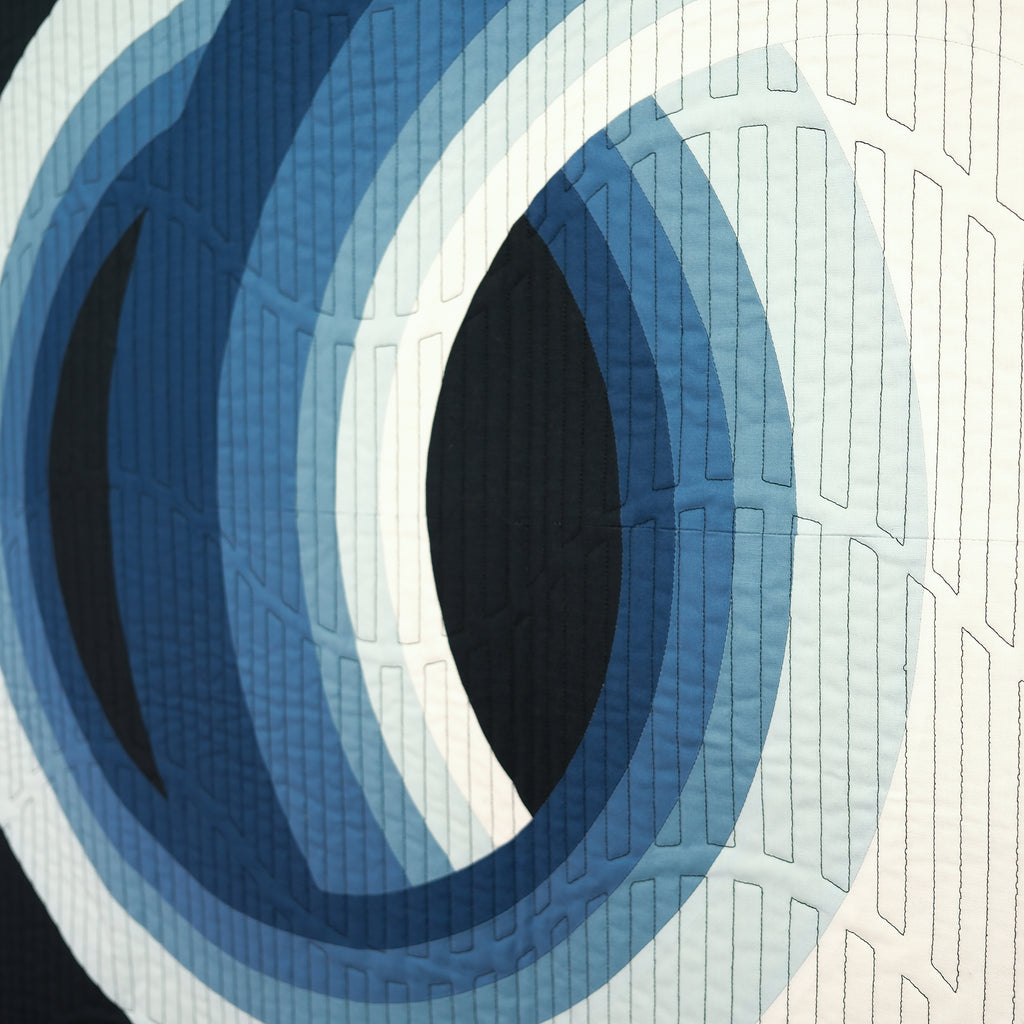 Abstract circular design with blue and white colors on a textured surface.