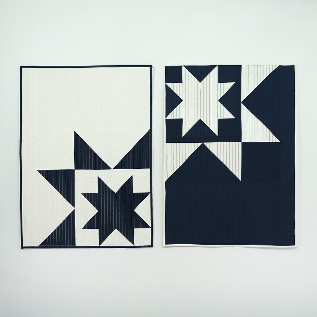 Two quilts with star patterns on navy and white backgrounds