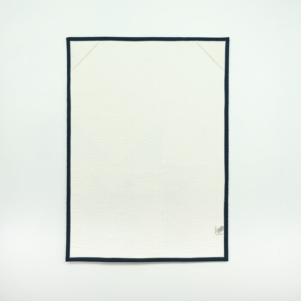 White quilt backing  with black border on a white background