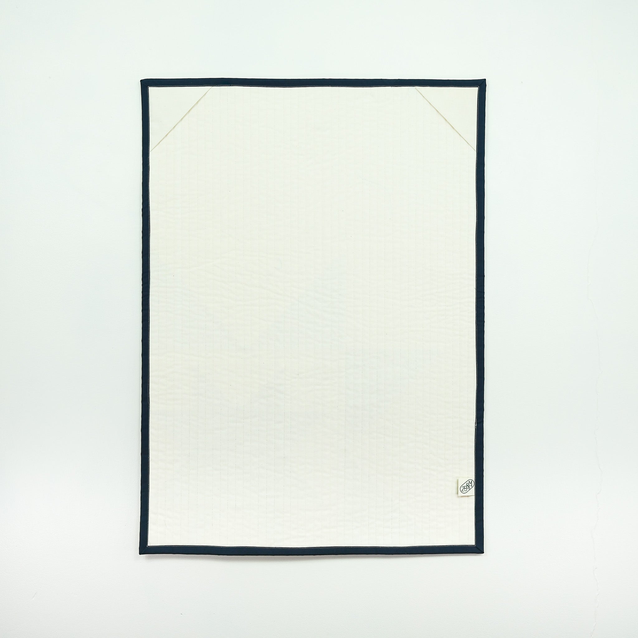 White quilt backing  with black border on a white background