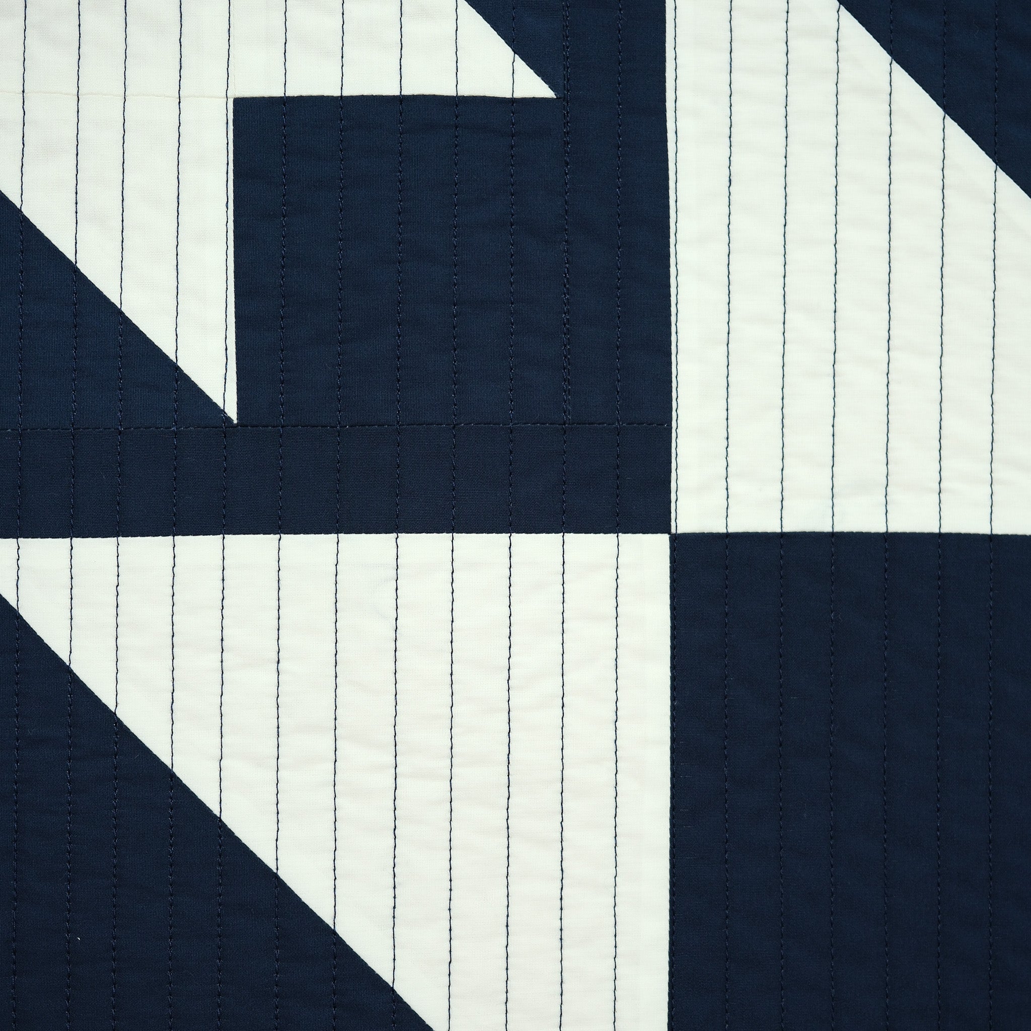 Navy and white quilt pattern with diagonal lines