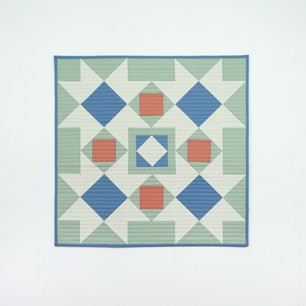 Quilt with geometric pattern on a white background