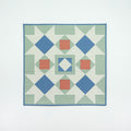 Quilt with geometric pattern on a white background