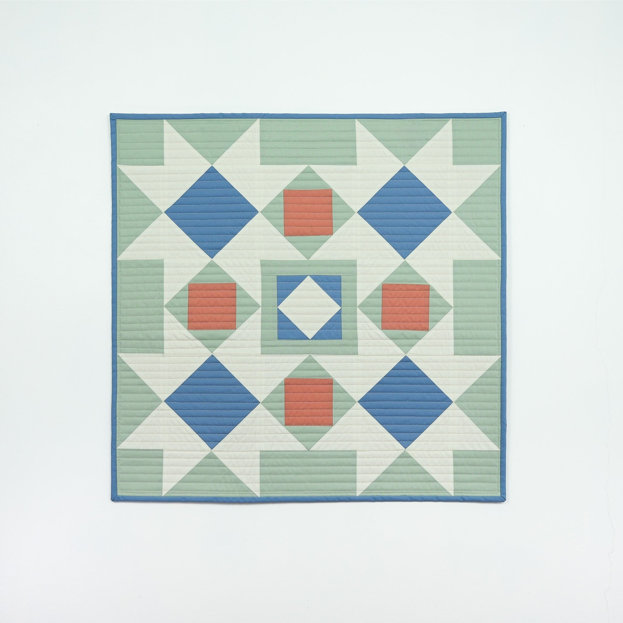 Quilt with geometric pattern on a white background