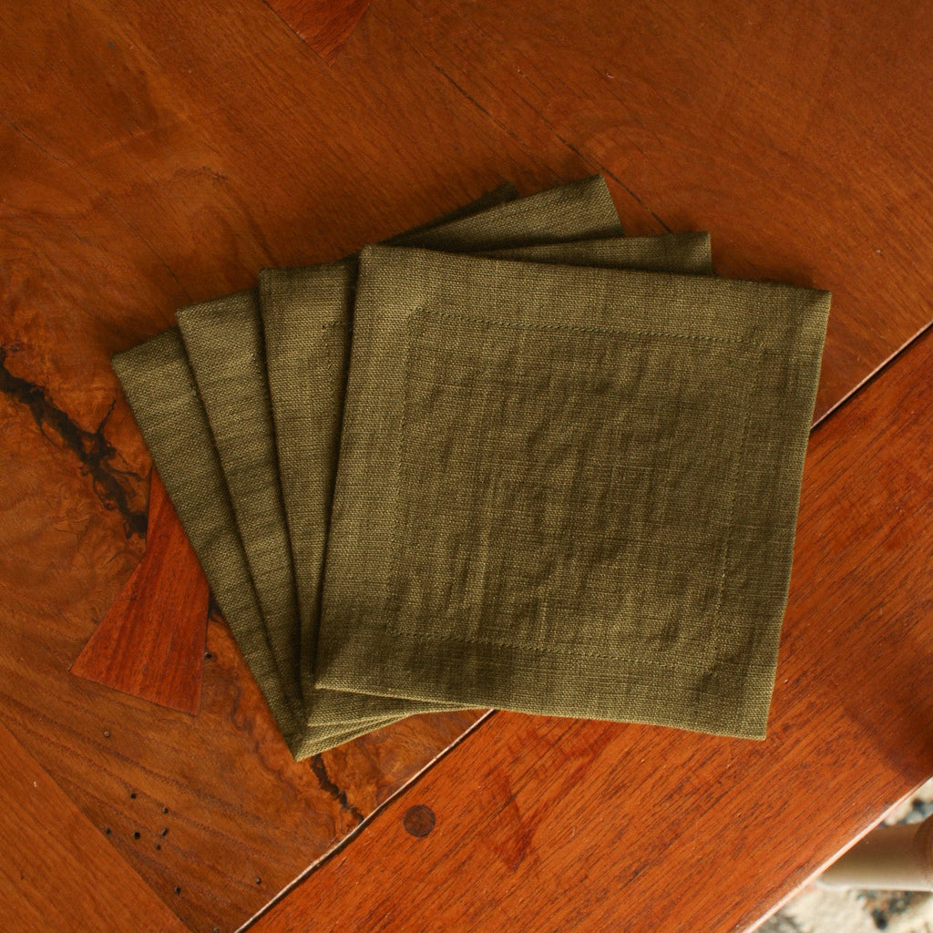 Set of green napkins on a wooden surface
