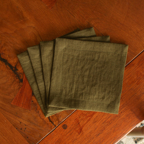 Set of green napkins on a wooden surface